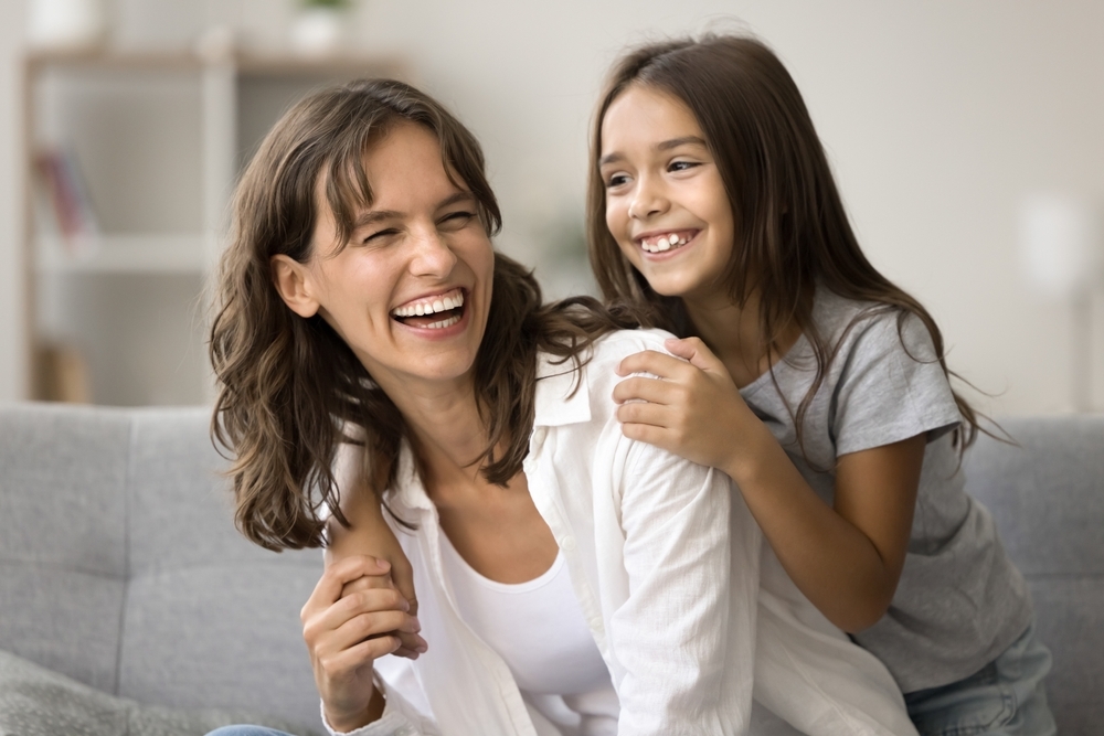 A smiling parent and child relaxing together